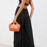 Solid color halter neck open back flared jumpsuit