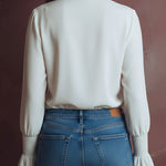 Elegant High Neck White Blouse With Smocked Cuffs And Ruffle Details