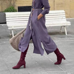 Satin shirt dress with a fitted waist and side slit.