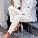 White blouse with a V-neckline and openwork sleeves