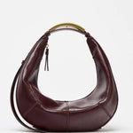 Metal handle crescent bag